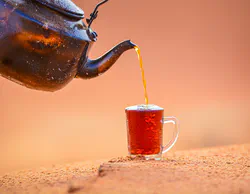 Teapot pouring on brown mug - e_i9